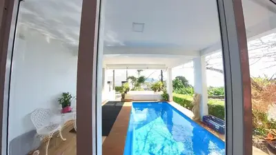 a swimming pool in the middle of a house at Sawansa 33B 425m2 Luxury Seaview Pool near Beach in Patong Beach