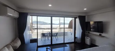 a room with a view of a balcony with a table and chairs at Sawansa 20 3BR 300m2 Modern Seaview house near Beach in Patong Beach