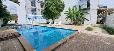 a swimming pool with two chairs and a building at Sawadee622,Naiharn & Rawai beach Phuket in Rawai Beach