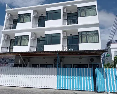 a white building with a fence in front of it at Sawadee622,Naiharn & Rawai beach Phuket in Rawai Beach