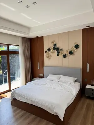 a bedroom with a large bed and a large window at Ocean Villa Bang Tao Phuket in Ban Thalat Choeng Thale