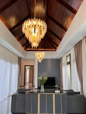 a living room with a ceiling with a chandelier at Ocean Villa Bang Tao Phuket in Ban Thalat Choeng Thale