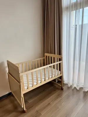 a crib in a room next to a window at Ocean Villa Bang Tao Phuket in Ban Thalat Choeng Thale