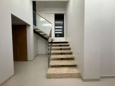 a staircase in a house with a glass railing at MANDARIN villa, Naithon beach, Phuket in Phuket