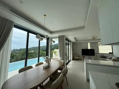a kitchen and living room with a table and chairs at MANDARIN villa, Naithon beach, Phuket in Phuket