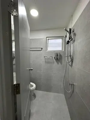 a bathroom with a shower and a toilet in it at Phuket Hostel at Rawai in Phuket Town