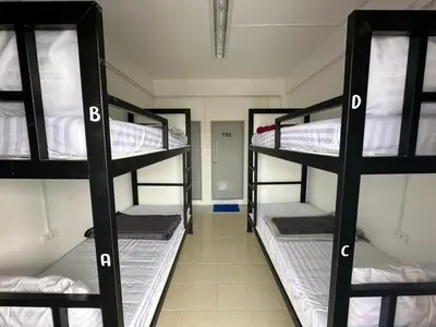 a room with three bunk beds in a dorm at Phuket Hostel at Rawai in Phuket Town