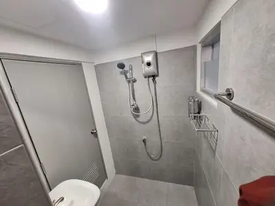 a shower stall in a bathroom with a toilet at Phuket Hostel at Rawai in Phuket Town