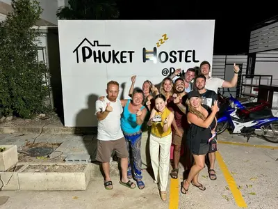 a group of people posing in front of a truck hostel at Phuket Hostel at Rawai in Phuket Town