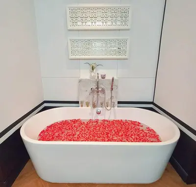 a bath tub filled with red peppers in a bathroom at Skyframe pool villa near Bangtao beach, Bluetree, Thalang in Ban Pak Lak