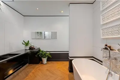 a bathroom with a white tub and a sink at Skyframe pool villa near Bangtao beach, Bluetree, Thalang in Ban Pak Lak