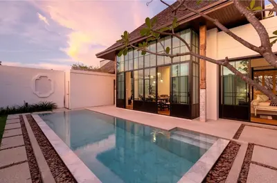 a swimming pool in front of a house at Skyframe pool villa near Bangtao beach, Bluetree, Thalang in Ban Pak Lak