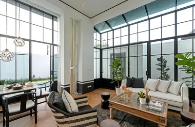 a living room with a couch and a table at Skyframe pool villa near Bangtao beach, Bluetree, Thalang in Ban Pak Lak