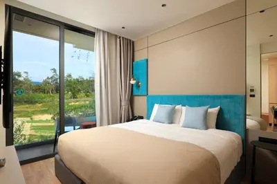 a bedroom with a large bed and a large window at New 1bdr apartment BangTao Beach C410 in Laguna Phuket