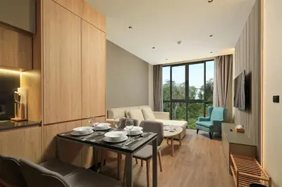 a living room with a table and chairs and a couch at New 1bdr apartment BangTao Beach C410 in Laguna Phuket