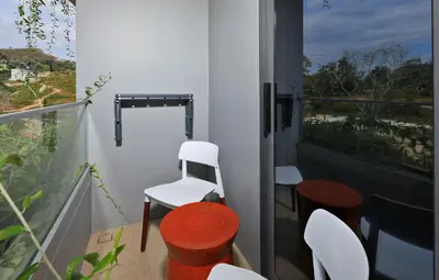 a balcony with two white chairs and a window at New 1bdr apartment BangTao Beach C410 in Laguna Phuket