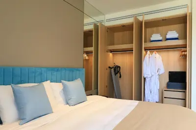 a bedroom with a bed with blue and white pillows at New 1bdr apartment BangTao Beach C410 in Laguna Phuket