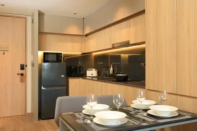 a kitchen with a table with plates and wine glasses at New 1bdr apartment BangTao Beach C410 in Laguna Phuket