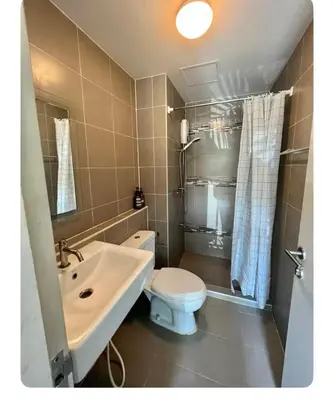 a bathroom with a white toilet and a sink at Dcondo kuku resort in Ban Phlu Yai