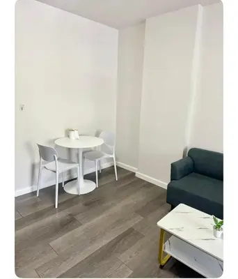 a living room with a white table and chairs at Dcondo kuku resort in Ban Phlu Yai