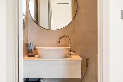 a bathroom with a sink and a mirror at Title Halo Holi Day 40m2 King Bed Pool View in Nai Yang Beach