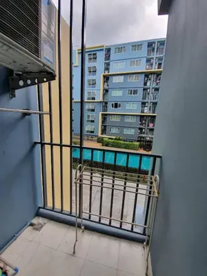 a balcony with a view of a large building at Dcondo Kathu Poolview by LaChambre Phuket in Phuket Town