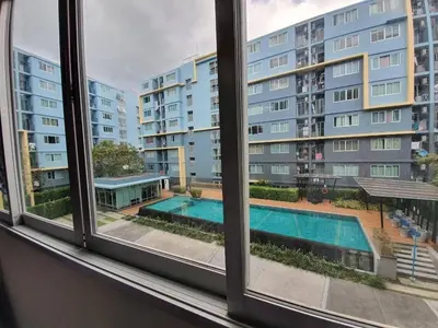 a view of a swimming pool from a window at Dcondo Kathu Poolview by LaChambre Phuket in Phuket Town