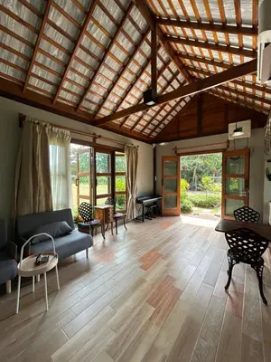 a living room with a couch and a table at Rawi Seaside Cottage, Ko Yao Noi in Ban Laem Sai