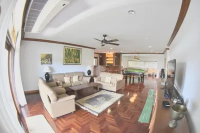 a living room with a couch and a table at Blue Canyon Country Club Golf Course Maikhao in Phuket