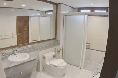 a bathroom with a toilet and a sink and a shower at Blue Canyon Country Club Golf Course Maikhao in Phuket