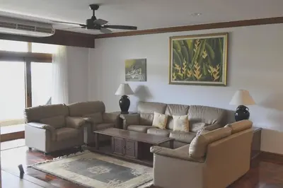 a living room with a couch and a table at Blue Canyon Country Club Golf Course Maikhao in Phuket