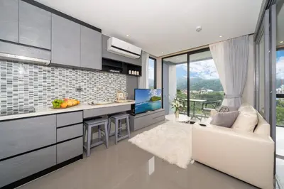 a kitchen with a white couch and a counter at Apartment 1 - bedroom Kamala in Kamala Beach