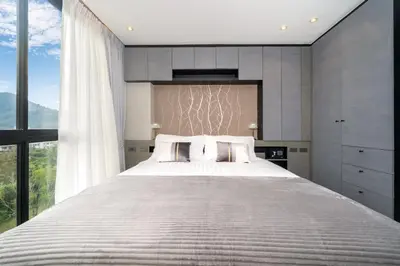 a bedroom with a large bed with a large window at Apartment 1 - bedroom Kamala in Kamala Beach