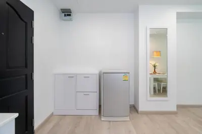 a kitchen with a refrigerator and a table at Phuket Villa 1 bedroom apartment in Patong in Patong Beach