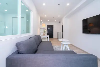 a living room with a couch and a table at Phuket Villa 1 bedroom apartment in Patong in Patong Beach