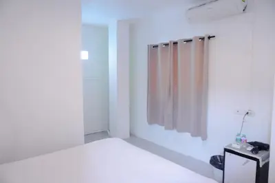 a white room with a bed and a shower at XX BAO Patong Beach Phuket II เบา ป่าตอง บีช ภูเก็ต in Patong Beach
