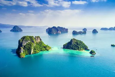 an island in the ocean with rocks in the water at XX BAO Patong Beach Phuket II เบา ป่าตอง บีช ภูเก็ต in Patong Beach
