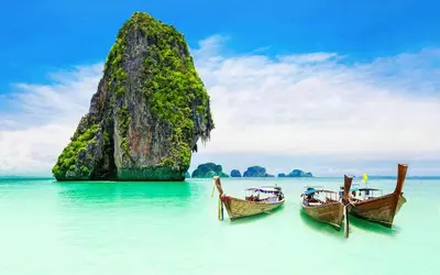 two boats in the water in front of a rock formation at XX BAO Patong Beach Phuket II เบา ป่าตอง บีช ภูเก็ต in Patong Beach