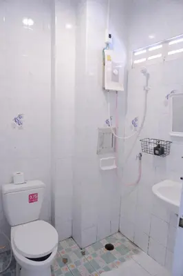 a white bathroom with a toilet and a sink at XX BAO Patong Beach Phuket II เบา ป่าตอง บีช ภูเก็ต in Patong Beach