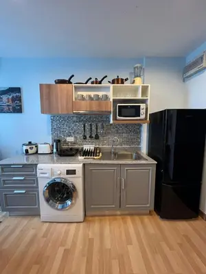 a kitchen with a sink and a washing machine at zcape 2 boat avenue 2 bedroom by sahana in Ban Thalat Choeng Thale