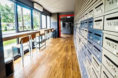 a room with a row of tables and chairs at zcape 2 boat avenue 2 bedroom by sahana in Ban Thalat Choeng Thale