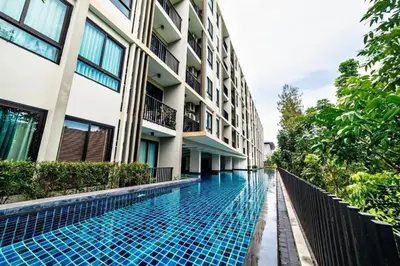 a swimming pool in front of a building at zcape 2 boat avenue 2 bedroom by sahana in Ban Thalat Choeng Thale
