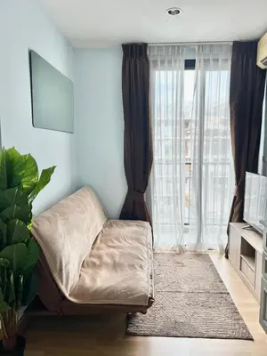 a living room with a couch and a large window at zcape 2 boat avenue 2 bedroom by sahana in Ban Thalat Choeng Thale