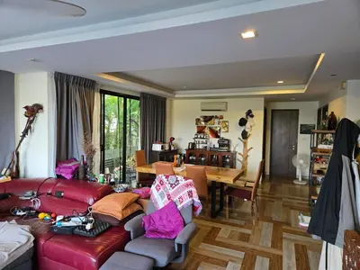 a living room with a red couch and a table at 4 bedroom Laguna Pool Villa in Laguna Phuket