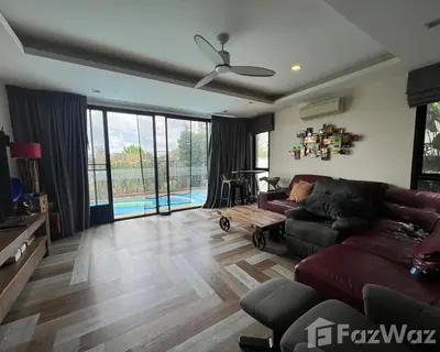 a living room with a couch and a ceiling fan at 4 bedroom Laguna Pool Villa in Laguna Phuket
