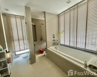 a bathroom with a tub and a shower with windows at 4 bedroom Laguna Pool Villa in Laguna Phuket