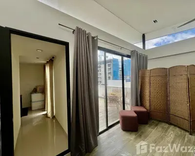 a living room with a large window and a balcony at 4 bedroom Laguna Pool Villa in Laguna Phuket
