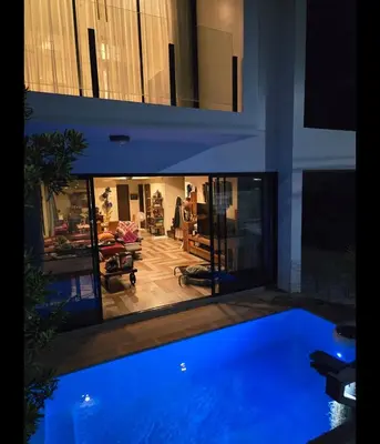 a large house with a blue pool in the middle at 4 bedroom Laguna Pool Villa in Laguna Phuket