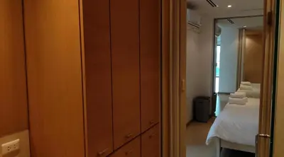 a bedroom with a bed and a dresser with a mirror at Thebirdhouse Patong Phuket 301 in Patong Beach