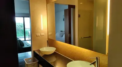 a bathroom with a sink and a large mirror at Thebirdhouse Patong Phuket 301 in Patong Beach